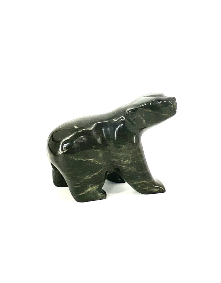 One original inuit hand carved sculpture made by Johnny Papigatukl in serpentine, from Cape Dorset, Nunavut ''Walking Bear 76-1246471''.