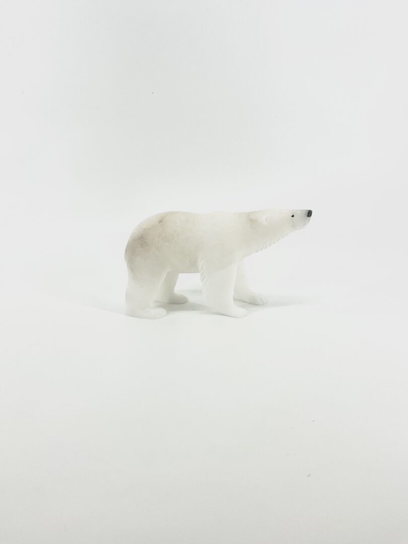 One original indigenous sculpture by Derrald Taylor. Walking polar bear made of white marble.