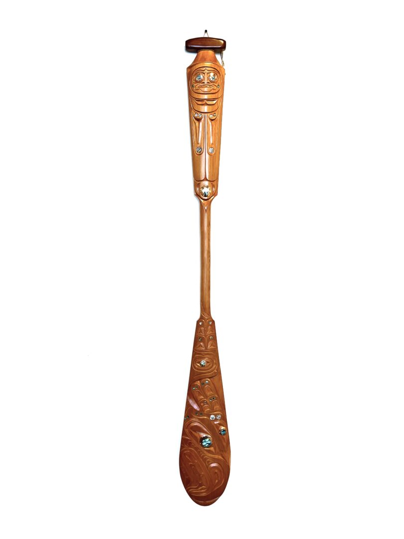One original hand-carved paddle made out of cedar wood with copper and abalone inlay, by Troy Kwakseesthala from Weiwakum.