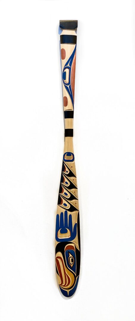 One hand-carved cedar wood paddle with acrylic paint by Indigenous artist Jason Henry Hunt from Kwakwaka'wawk.