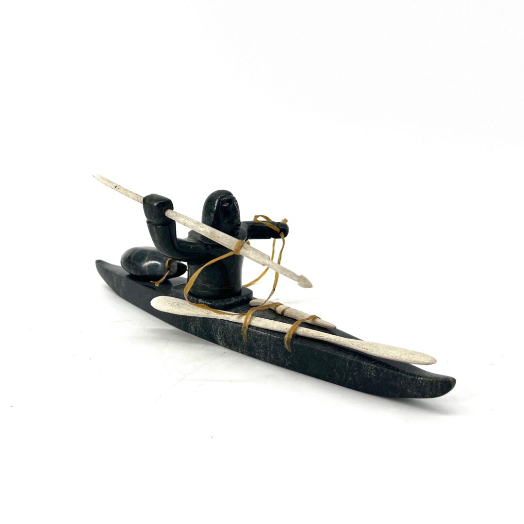One original hand-carved sculpture by Noah Jaw from Cape Dorset, Nunavut. One hunter on kayak made out of serpentine.