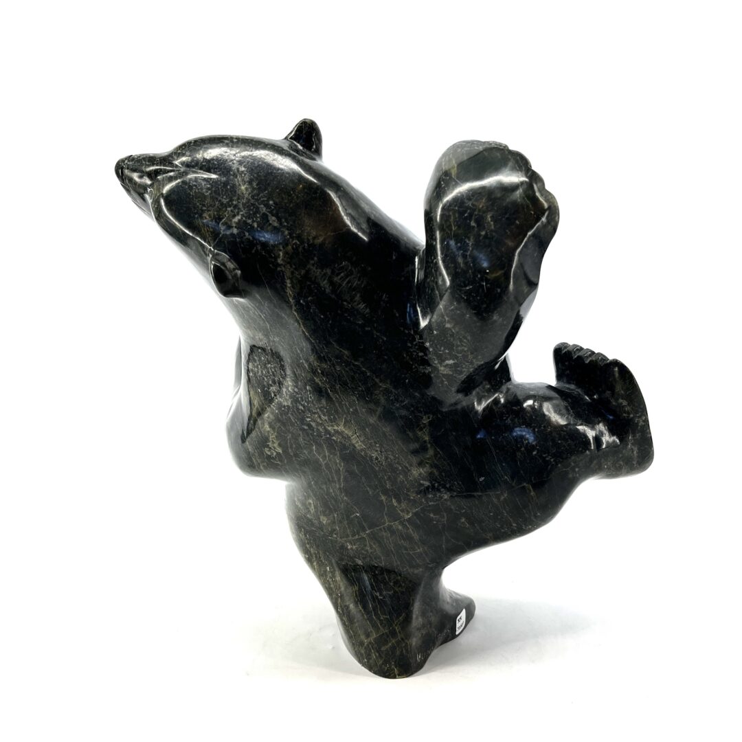 One original hand-carved sculpture by Nuna Parr from Cape Dorset, Nunavut. One dancing bear carved out of serpentine.