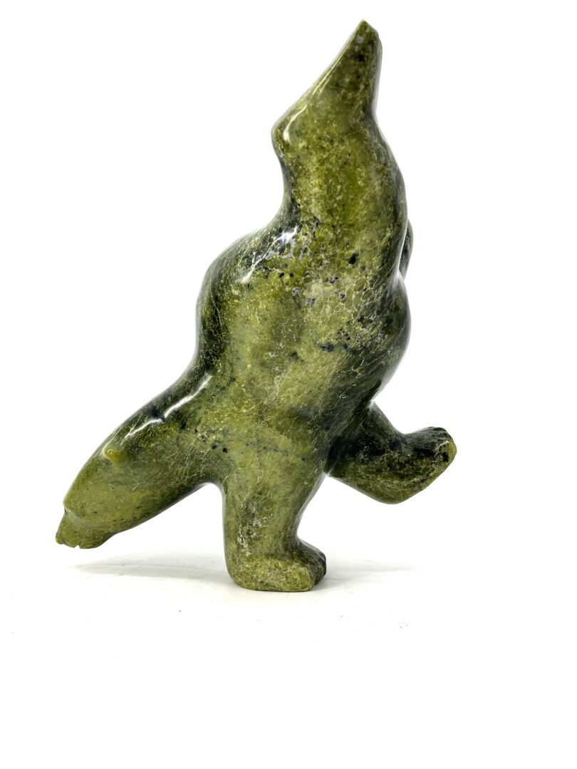 One original hand-carved sculpture by Johnny Manning from Iqaluit, Nunavut. Two-way diving bear made out of serpentine.