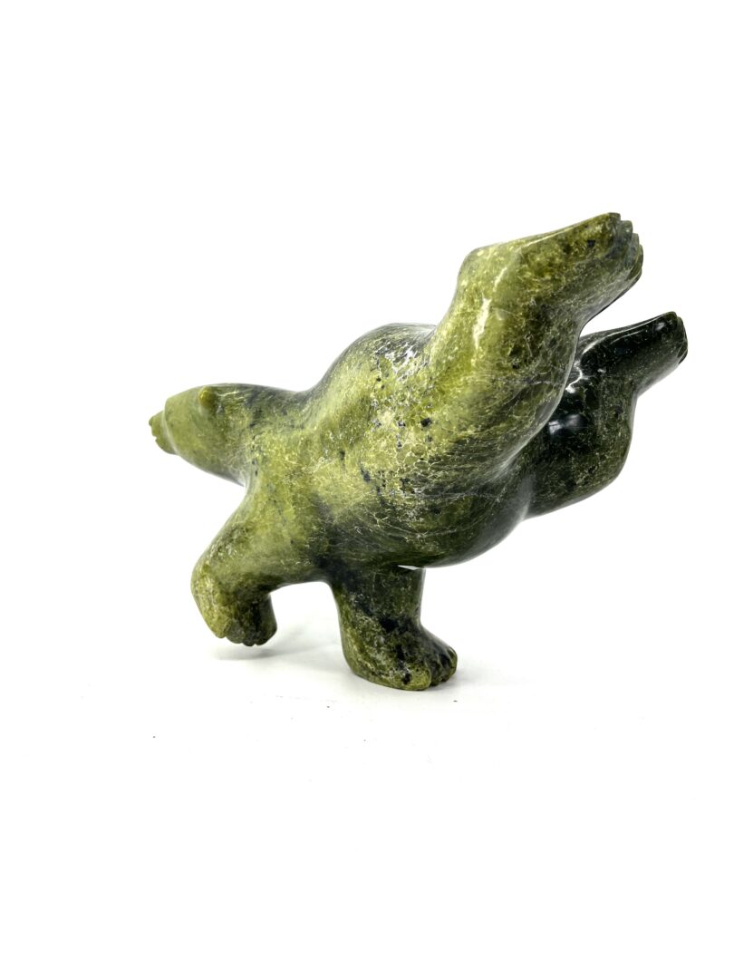 One original hand-carved sculpture by Johnny Manning from Iqaluit, Nunavut. Two-way diving bear made out of serpentine.