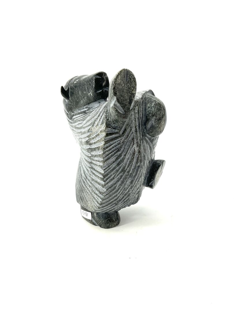 One original hand-carved sculpture by Pitseolak Qimirpik from Cape Dorset, Nunavut. One dancing muskox made out of serpentine.