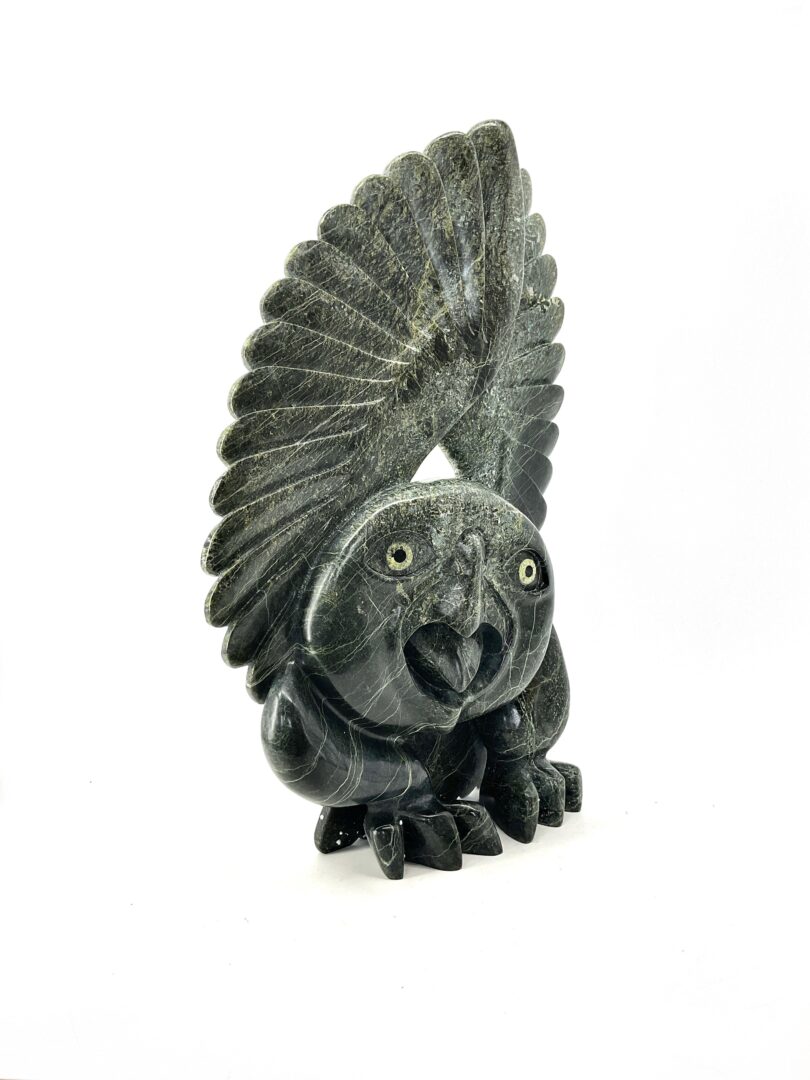 One original hand-carved sculpture by Toonoo Sharky from Cape Dorset, Nunavut. Owl sculpture made out of green serpentine.