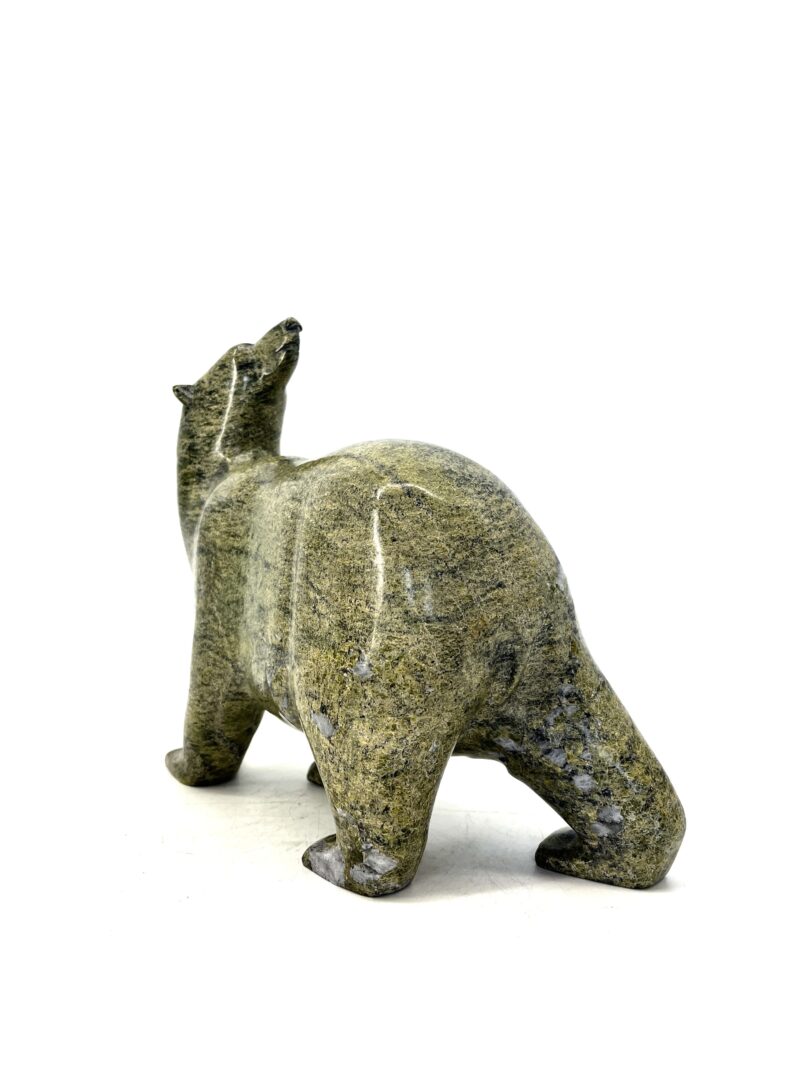 One original hand-carved sculpture by Inuit artist Time Pee. Walking bear sculpted out of green serpentine.