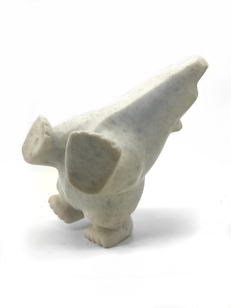 One original hand-carved sculpture by Joanie Ragee from Cape Dorset, Nunavut. One four-way bear made out of white marble.