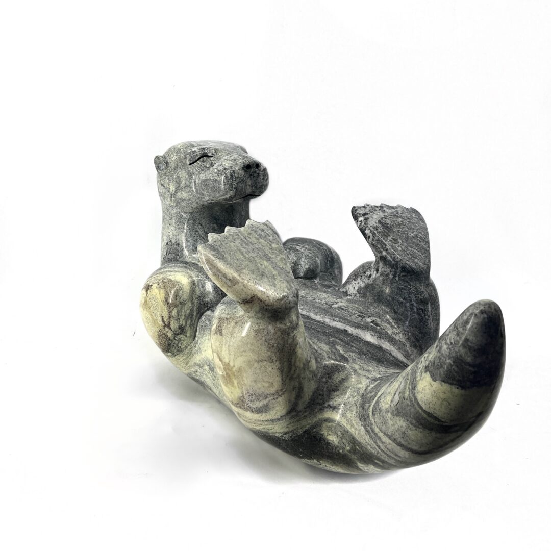 One original hand-carved sculpture by Ojibway artist, Paul Bruneau. One otter sculpted out of serpentine stone.
