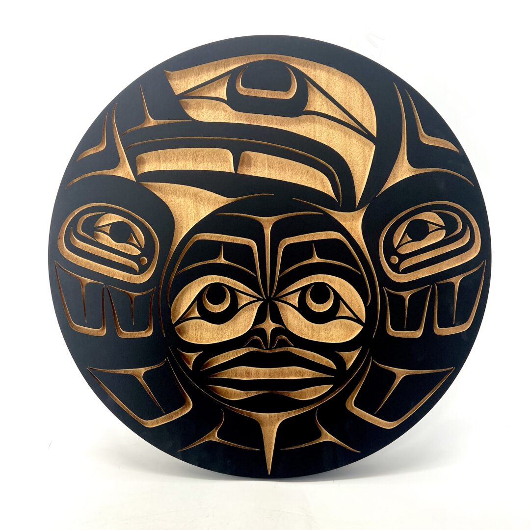 One original sand-blasted panel by Nuxalk artist, Nusmata. One Raven and the sun panel made out of cedar wood.