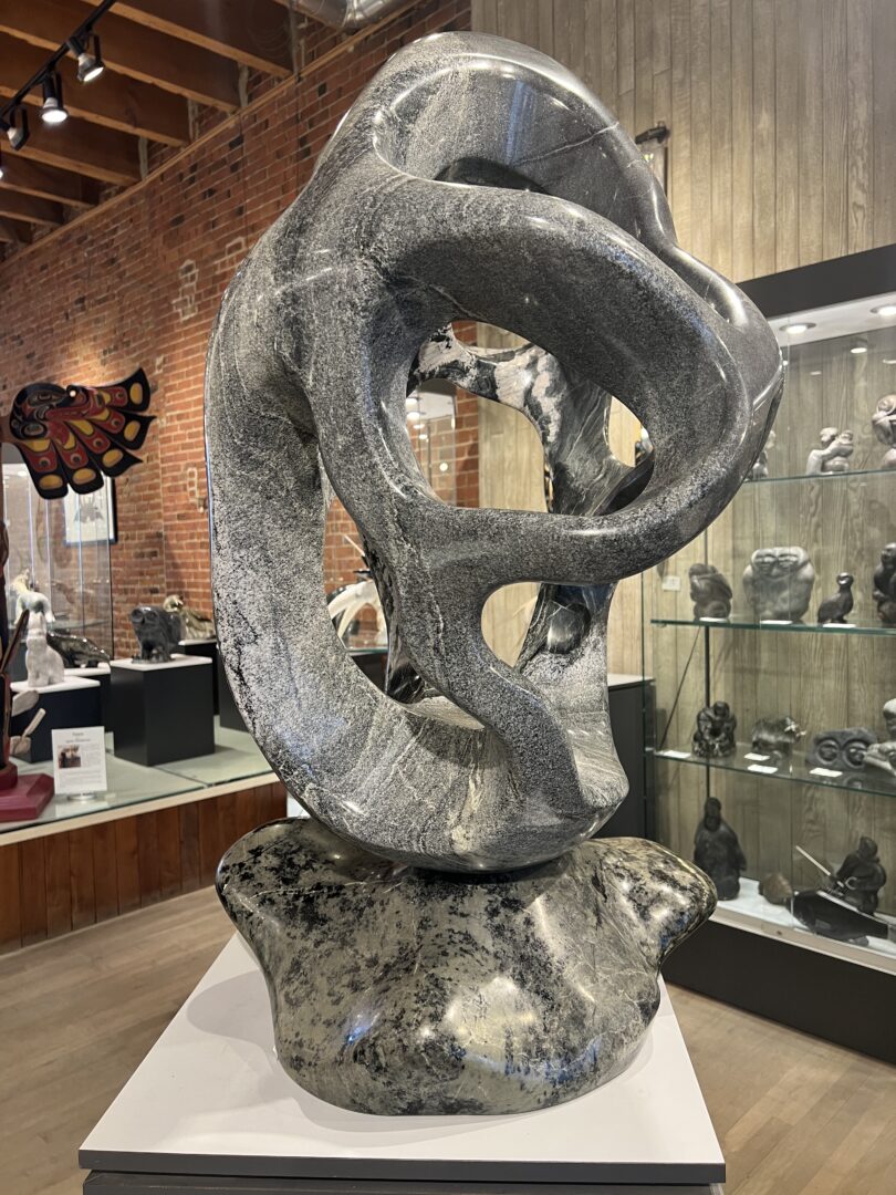 One original hand-carved piece by Ojibway artist Paul Bruneau. One abstract piece sculpted out of serpentine.