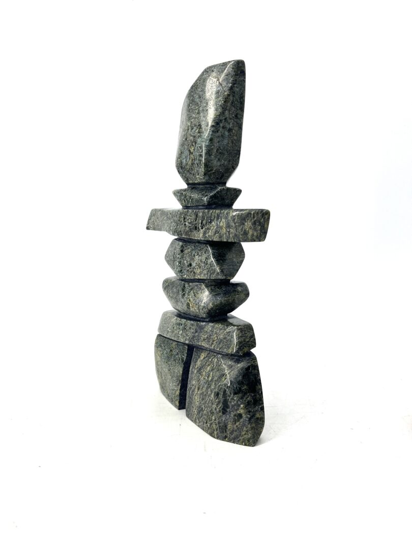 One original sculpture hand-carved by Mathewsie Oshutsiaq from Cape Dorset. One inukshuk made out of serpentine.