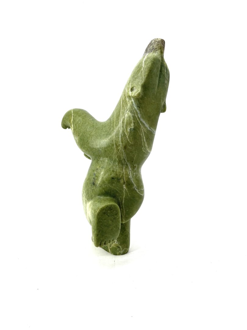 One original hand-carved sculpture by Palaya Qiatsuq from Cape Dorset. One dancing bear made out of green serpentine.