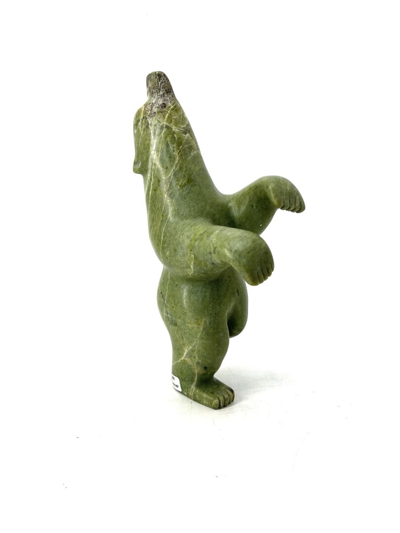 One original hand-carved sculpture by Palaya Qiatsuq from Cape Dorset. One dancing bear made out of green serpentine.
