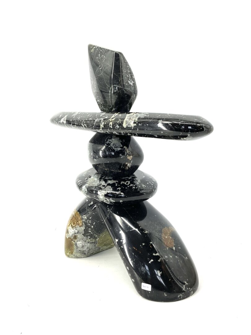 One original hand-carved sculpture by Ojibway artist, Paul Bruneau. One inukshuk sculpted out of serpentine.