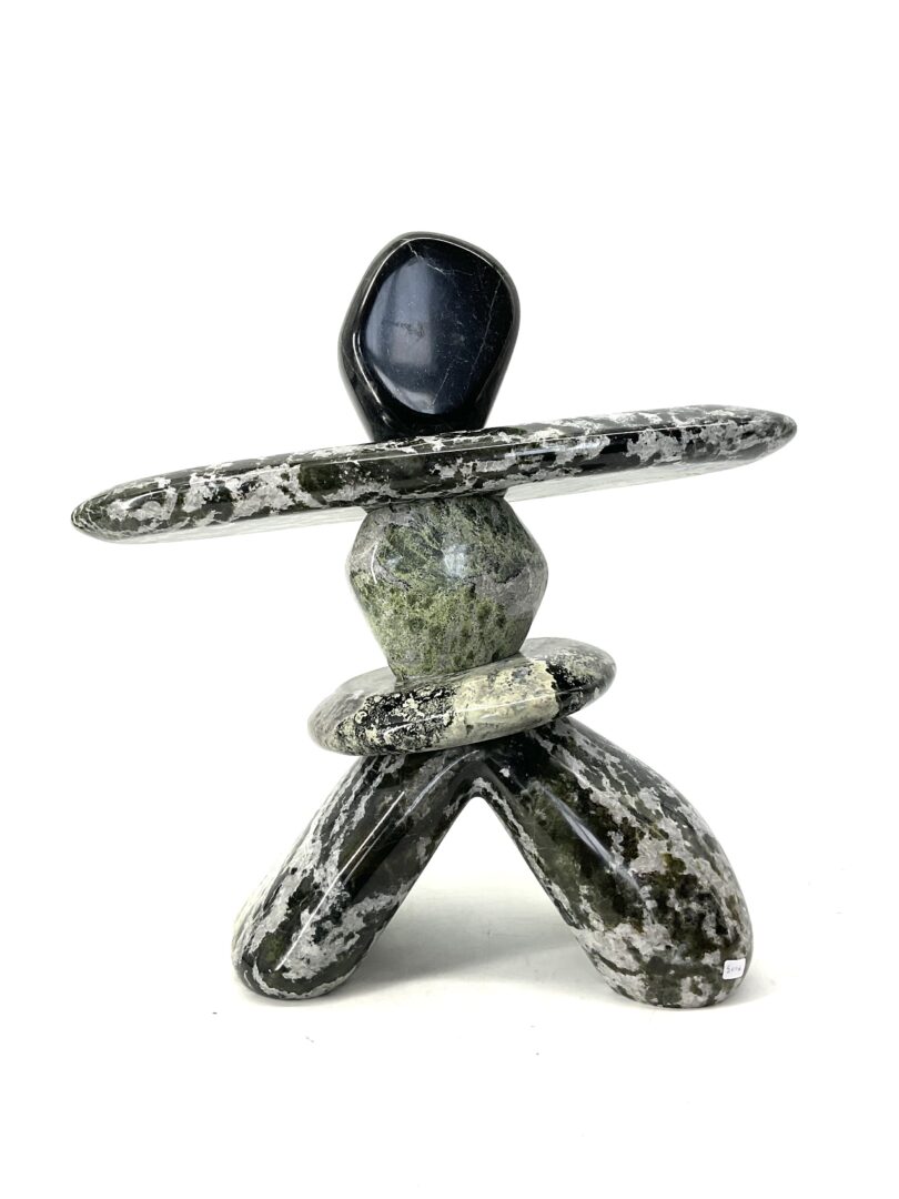 One original hand-carved sculpture by Ojibway artist, Paul Bruneau. One inukshuk sculpture made out of serpentine.