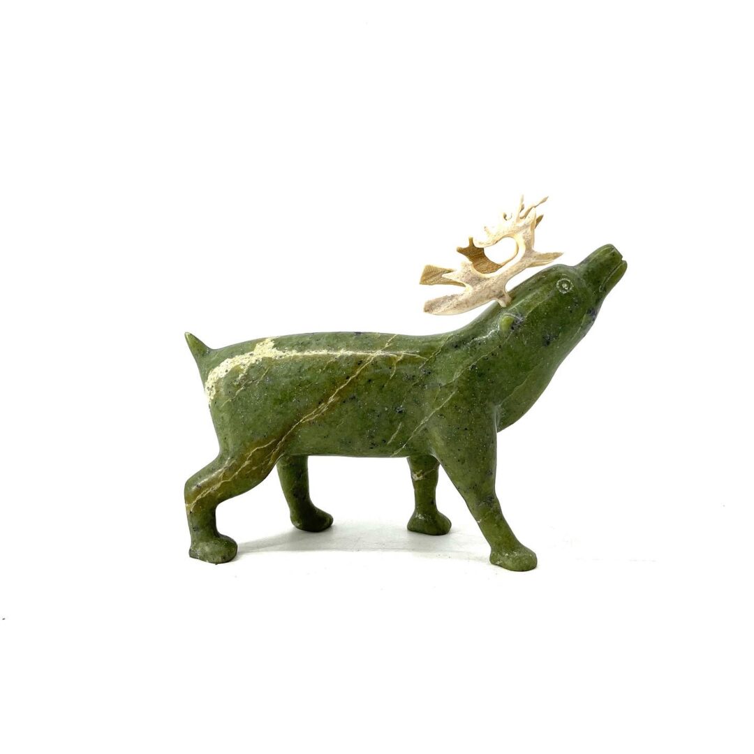 One original hand-carved sculpture by Inuit artist, Peter Aningmiuq. One caribou made out of green serpentine.
