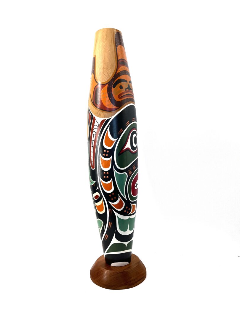 One original hand-carved cradle rattle by Johnathan Henderson. Sculpted out of cedar wood and acrylic paint.