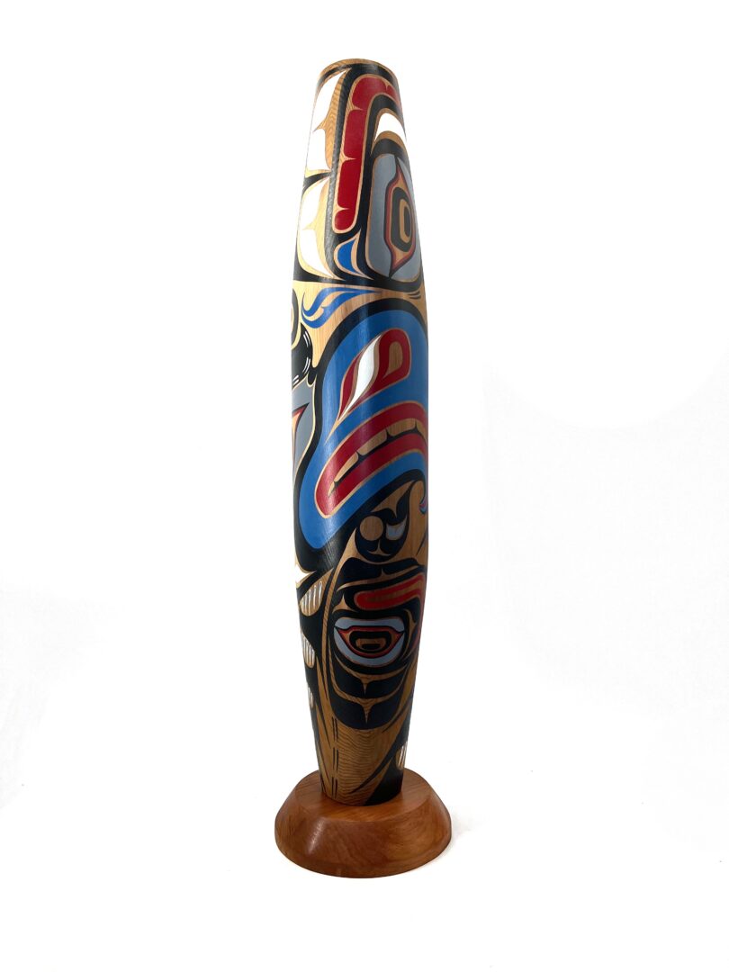 One original hand-carved cradle rattle by Kwakwak'wakw artist, Johnathan Henderson. One Kulus design cradle rattle.