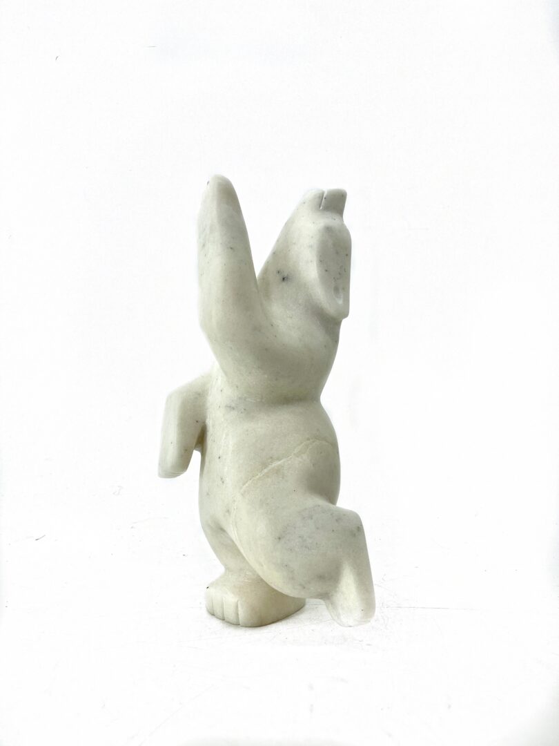 One original hand-carved sculpture by Inuit artist Adamie Mathewsie. One dancing bear made out of white marble.