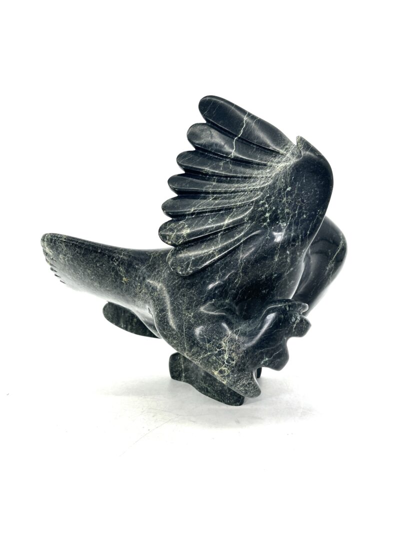 One original hand-carved sculpture by Inuit artist, Toonoo Sharky. One falcon sculpture made out of serpentine.