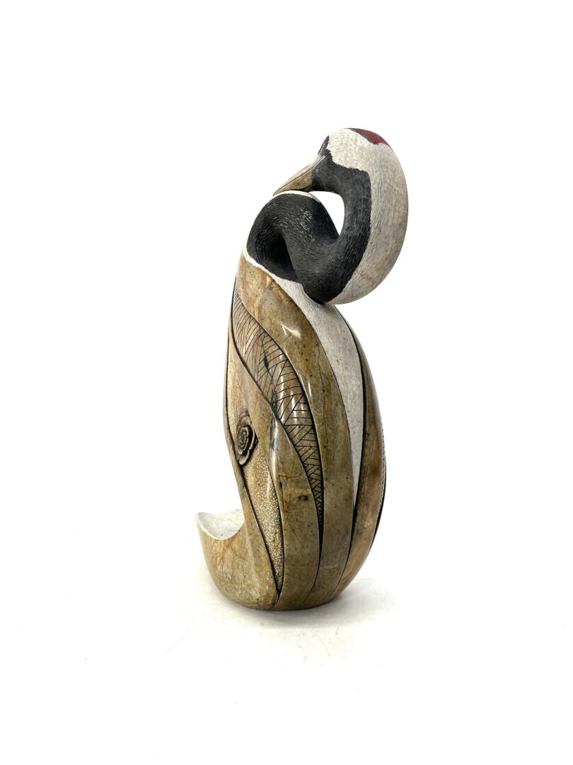 One original hand carved sculpture by Iroquois artist Eric Silver. One crane sculpture made out of soapstone.