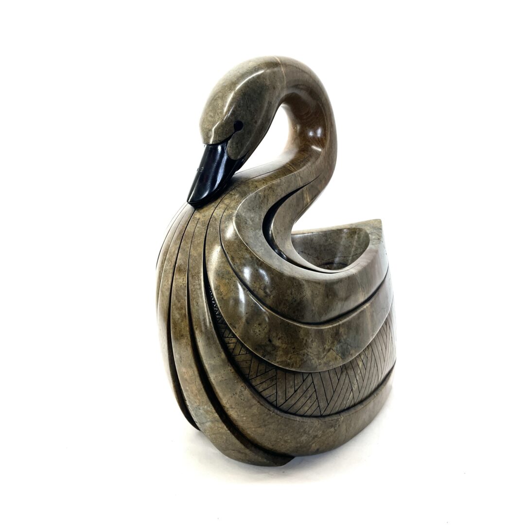 One original hand-carved sculpture by Iroquois artist, Eric Silver. One swan sculpture carved out of soap stone.