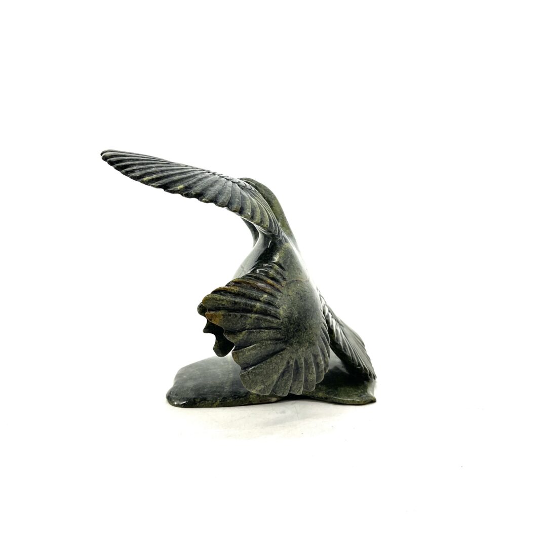 One original hand-carved sculpture by Inuit artist, Kelly Etidloie. One bird sculpture made out of serpentine.