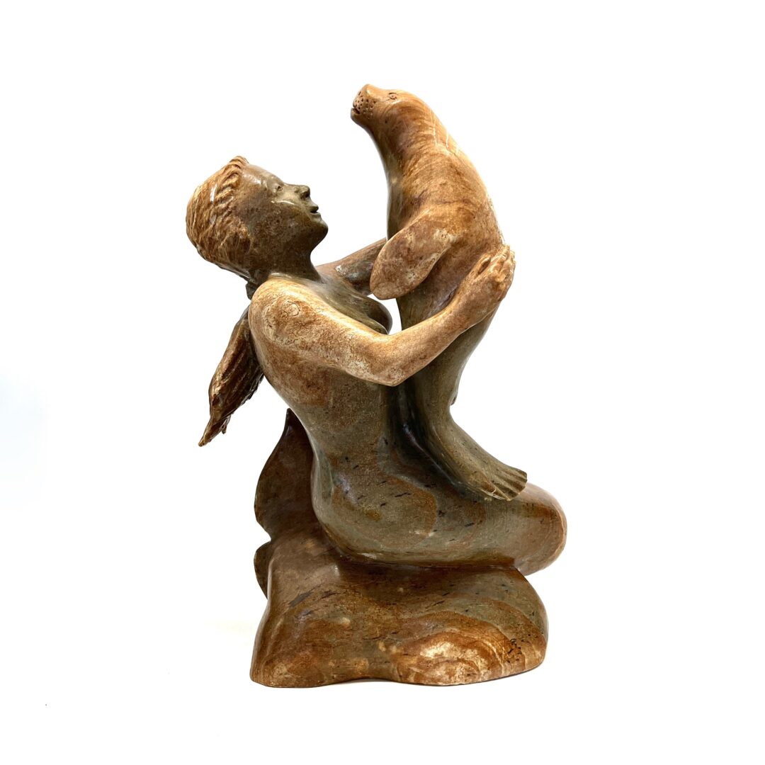 One original hand-carved sculpture by Inuit artist, Bill Nasogaluak. One Sedna and seal sculpture out of soapstone.
