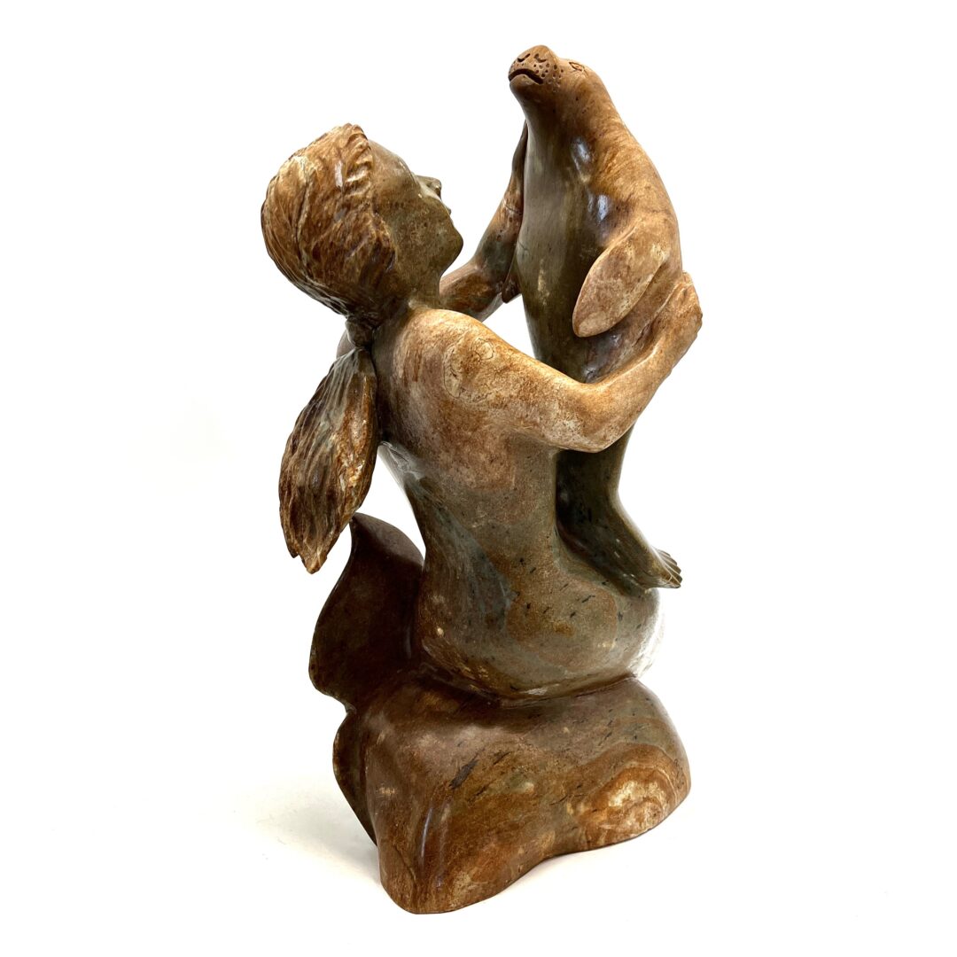 One original hand-carved sculpture by Inuit artist, Bill Nasogaluak. One Sedna and seal sculpture out of soapstone.