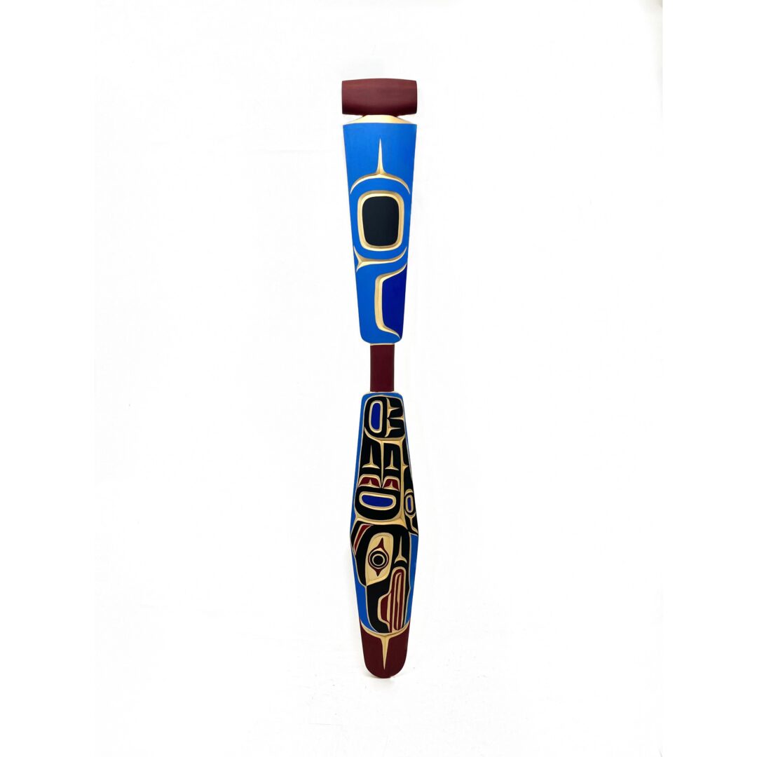 One original hand-carved paddle by Kwakwak'wakw artist, Peter Smith. One raven paddle carved out of cedar wood with acrylic paint.