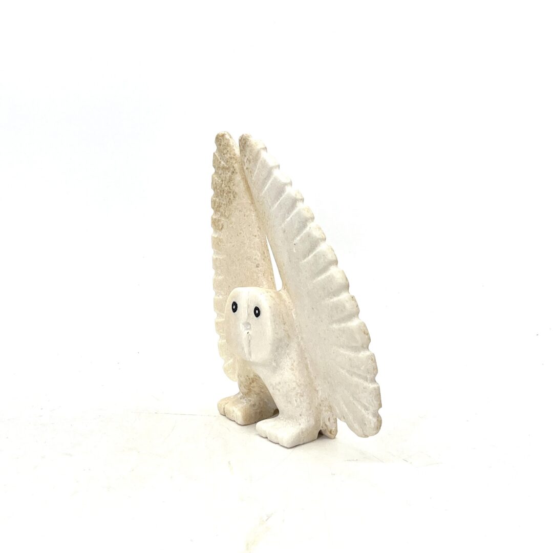 One original hand-carved sculpture by Inuit artist, Palaya Qiatsuk. One dancing owl sculpture made out of white marble