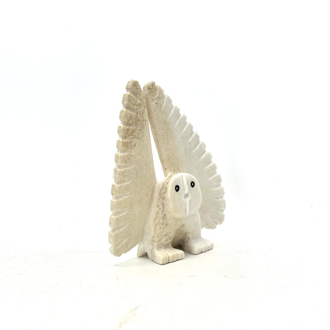 One original hand-carved sculpture by Inuit artist, Palaya Qiatsuk. One dancing owl sculpture made out of white marble
