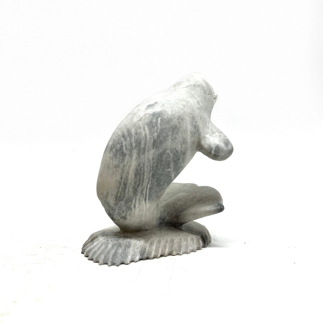 One original hand-carved sculpture by Inuit artist, Dan Aula. One whale and base made out of white marble.