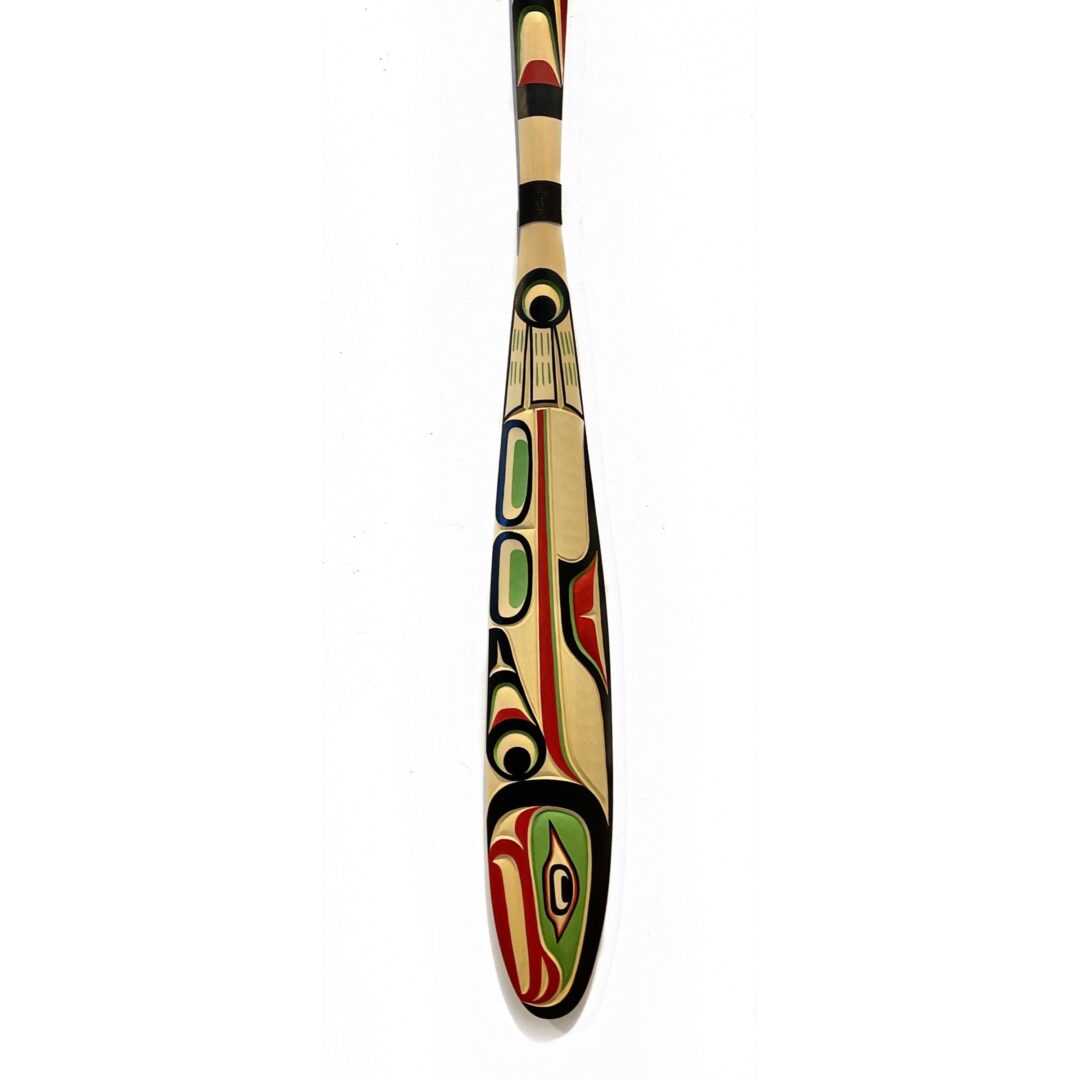 One original hand-carved paddle by Kwakwak'wakw artist, Jason Henry Hunt. One spawning salmon paddle carved out of cedar wood.