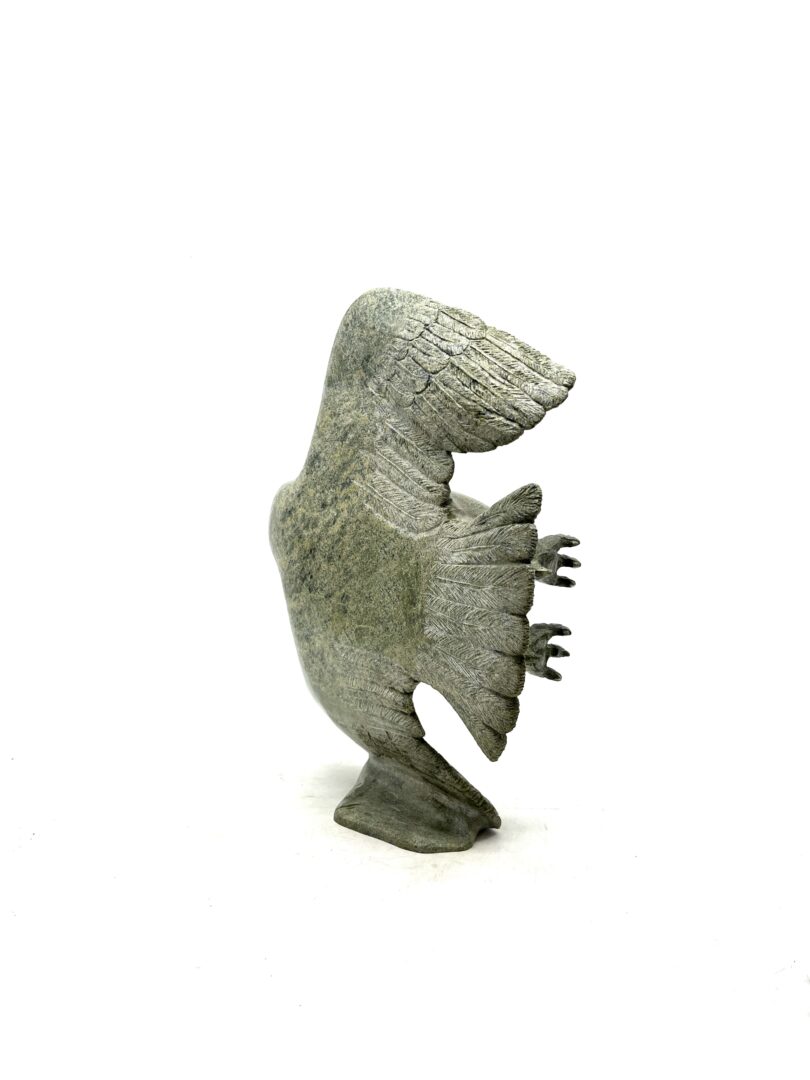 One original hand-carved sculpture by Inuit artist, David Panneok. One eagle in flight made out of serpentine.