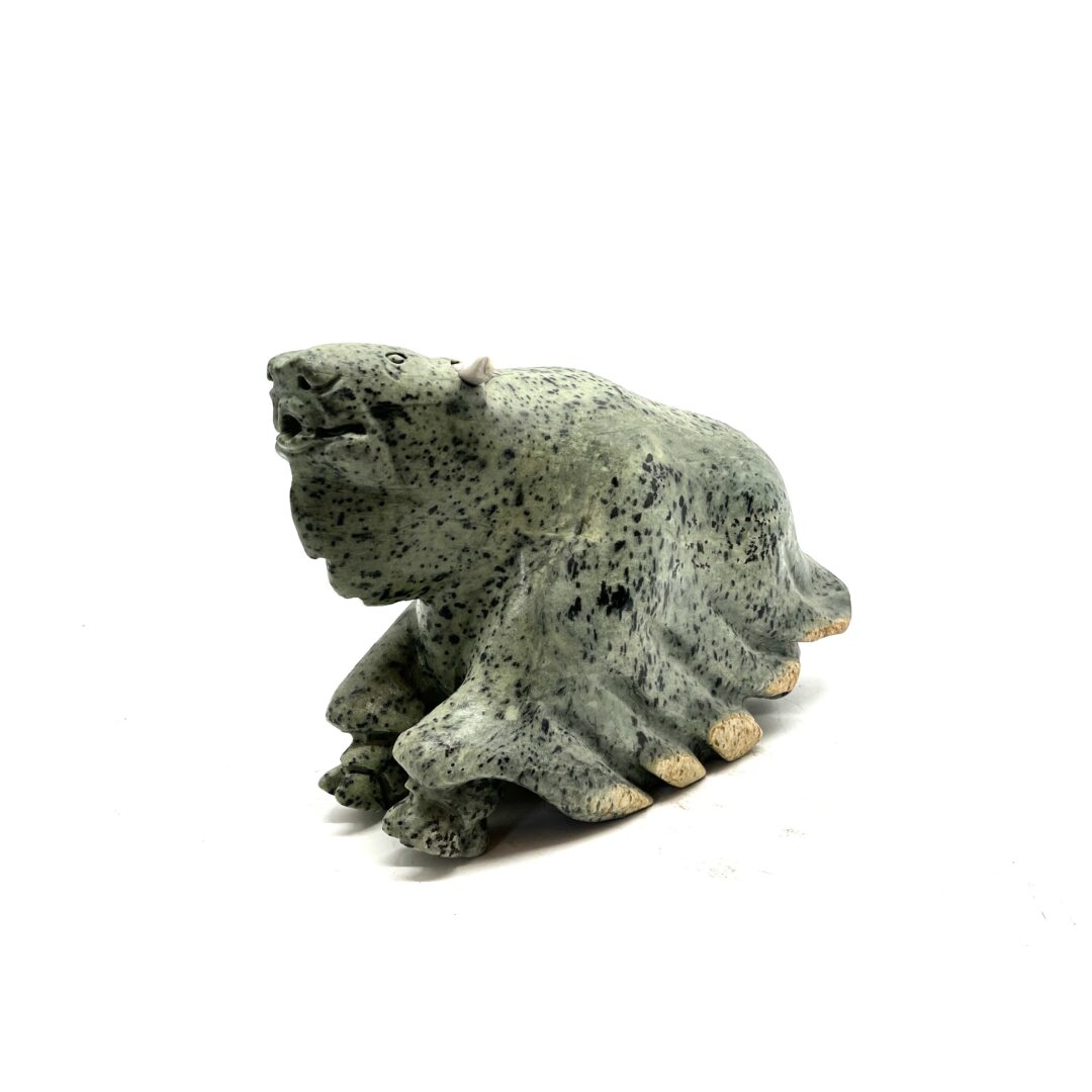 One original hand-carved sculpture by Inuit artist, Joanasie Faber. One musk-ox piece carved out of soapstone.