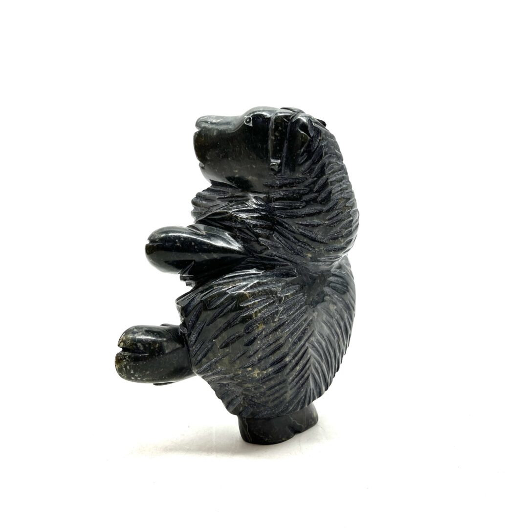 One original hand-carved sculpture by Inuit artist, Pitsulak Qimirpik. One dancing musk-ox made out of serpentine.