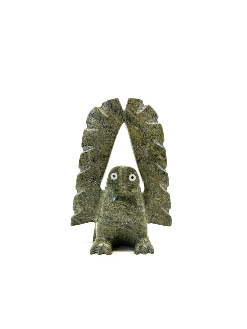 One original hand-carved sculpture by Inuit artist, Adamie Qaumaqiaq. One owl carved in serpentine with white marble inlay.