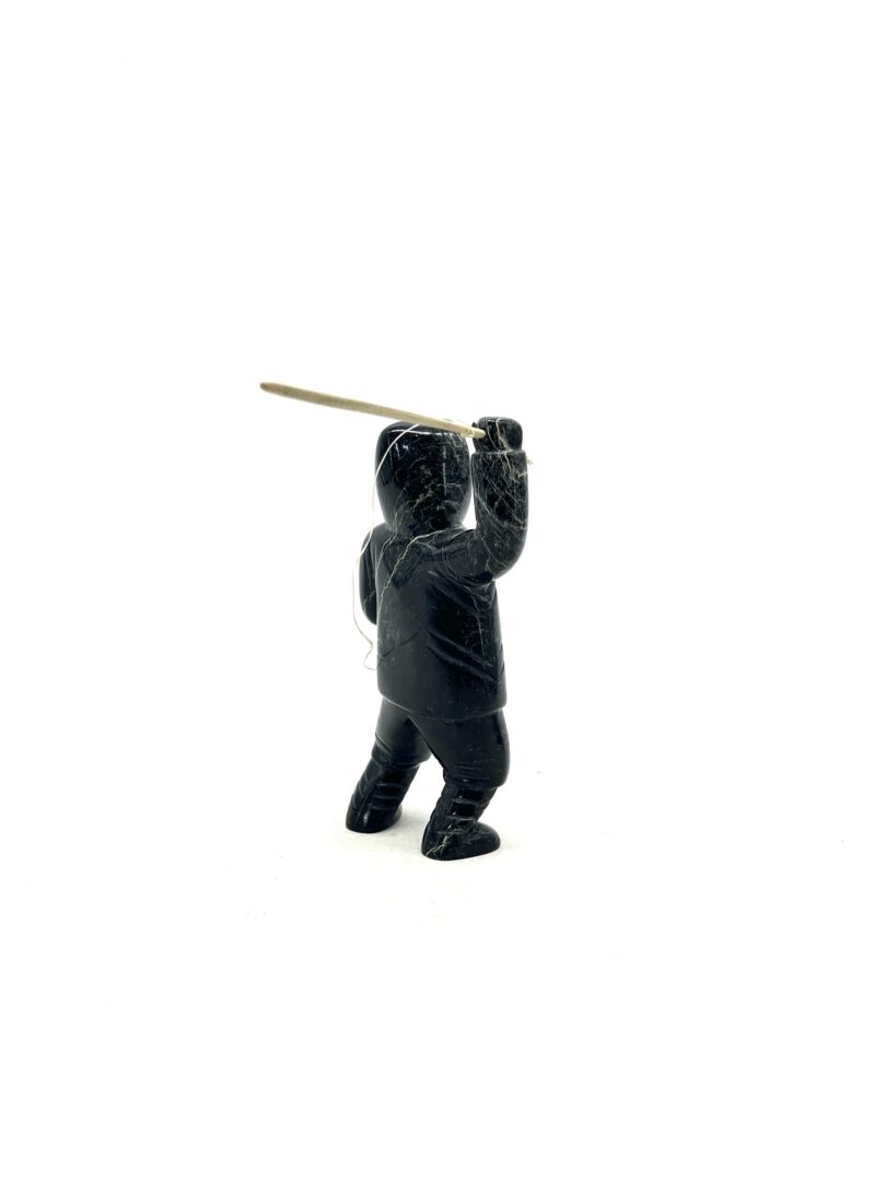 One original hand-carved sculpture by Inuit artist, Pitseolak Qimirpik. One hunter with harpoon made out of serpentine.
