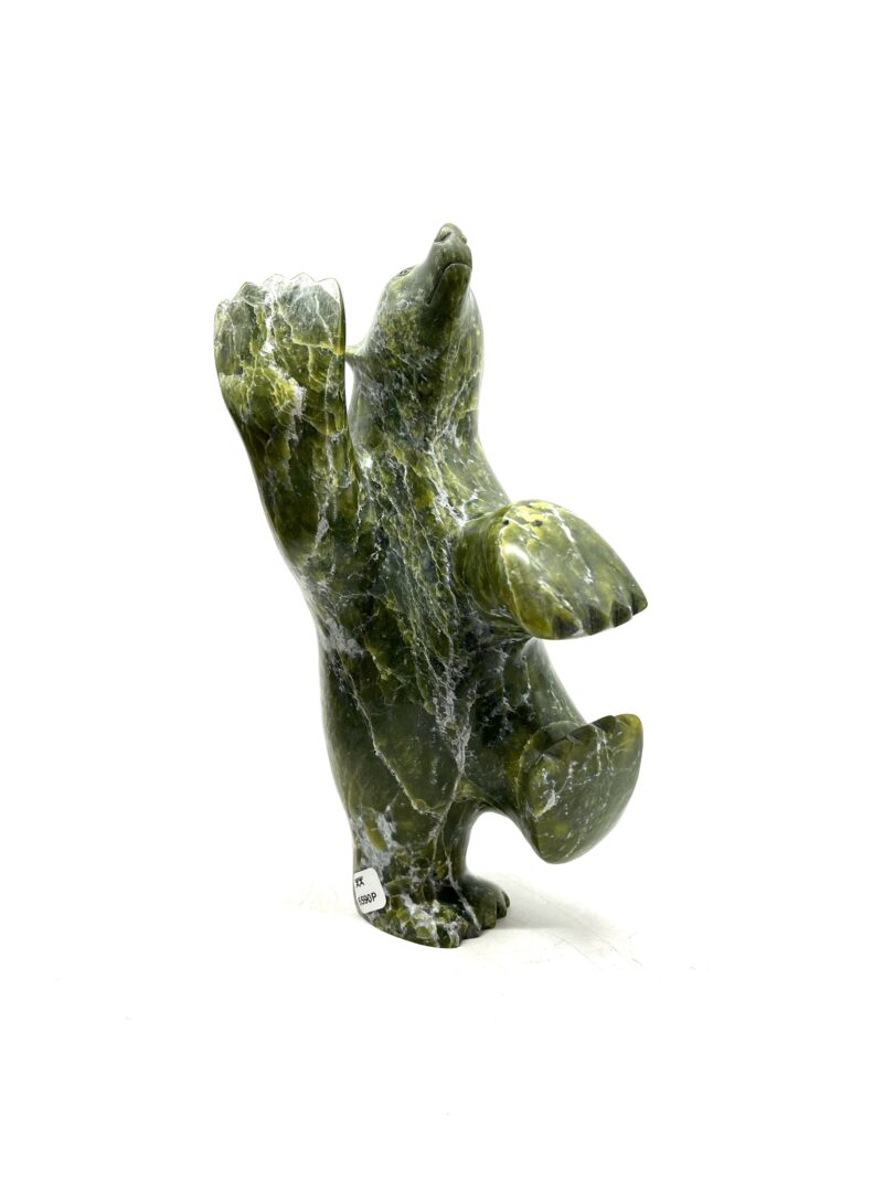 One original hand-carved sculpture by Inuit artist, Ashevak Adla. One dancing bear sculpted out of serpentine.