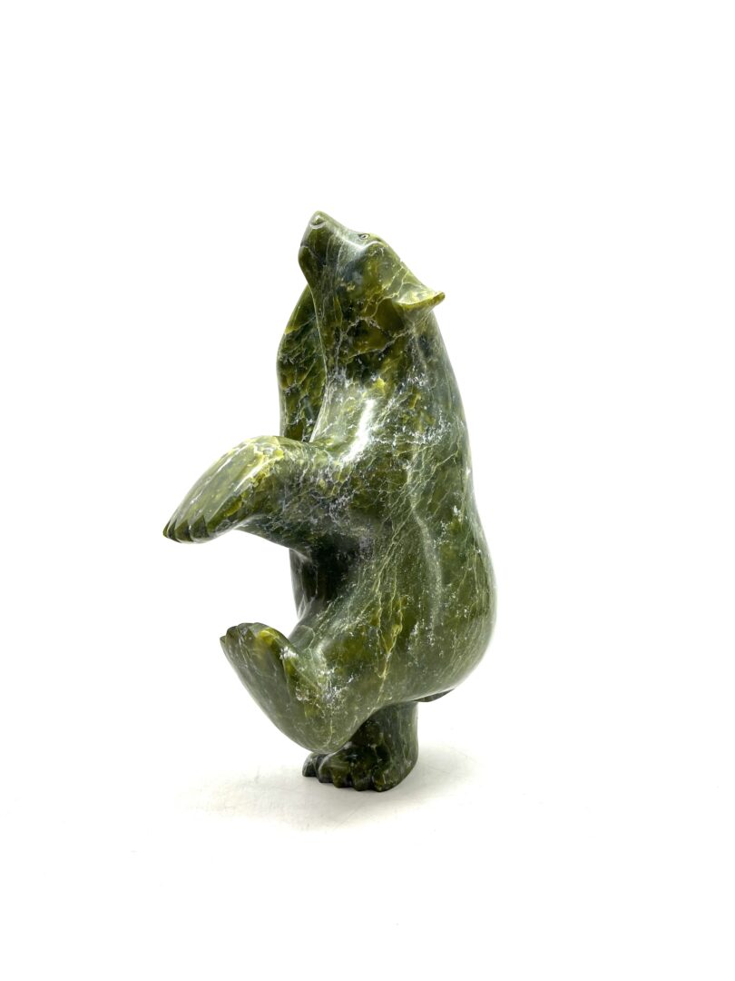 One original hand-carved sculpture by Inuit artist, Ashevak Adla. One dancing bear sculpted out of serpentine.