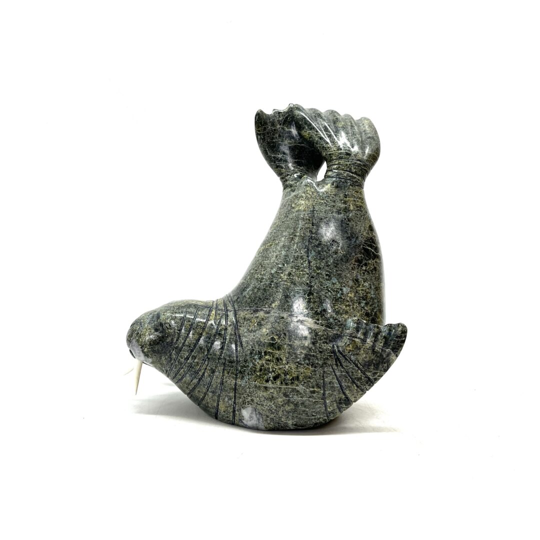 One original hand-carved sculpture by Inuit artist, Emataluk Saggiak. One walrus carved out of serpentine and caribou antler.