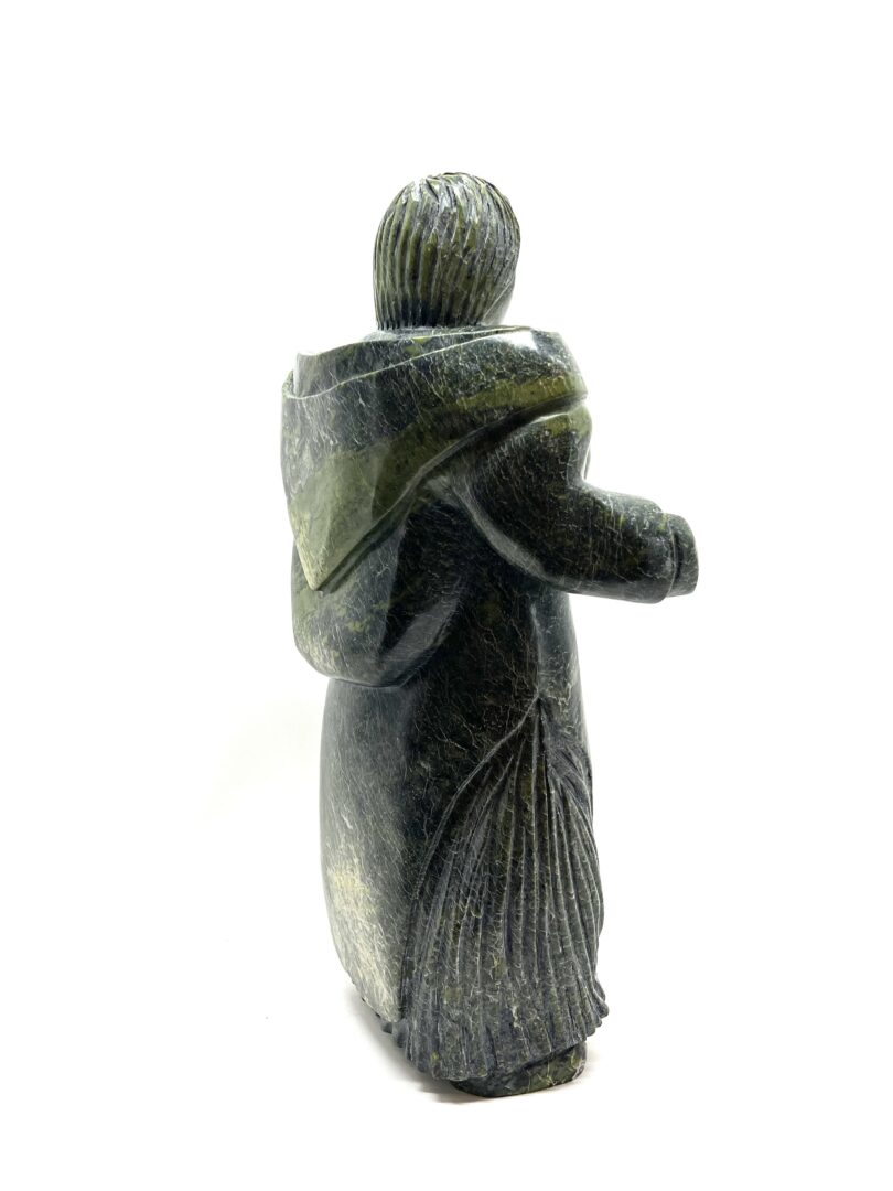 One original hand-carved sculpture by Inuit artist, Pits Qimirpik. One woman with berries carved out of green serpentine.