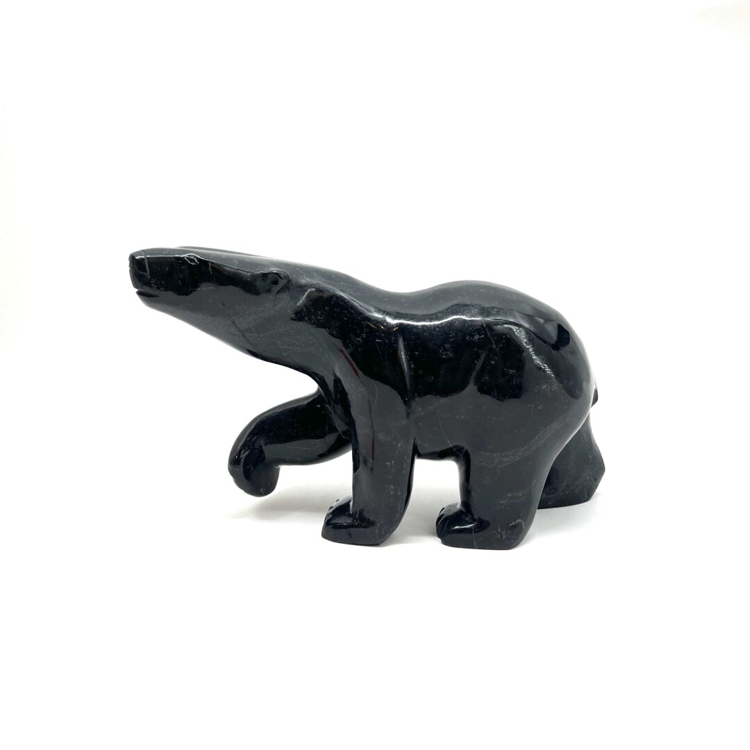 One original hand-carved sculpture by Inuit artist, Quaraq Nungusuitok. One walking bear carved out of serpentine.