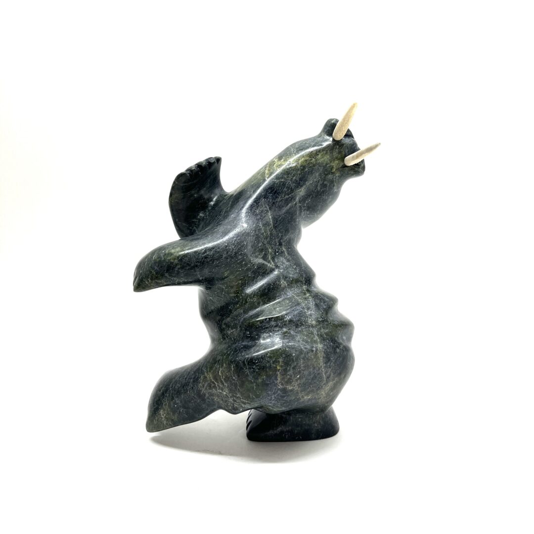 One original hand-carved sculpture by Inuit artist, Palaya Qiatsuq. One dancing walrus carved out of serpentine.