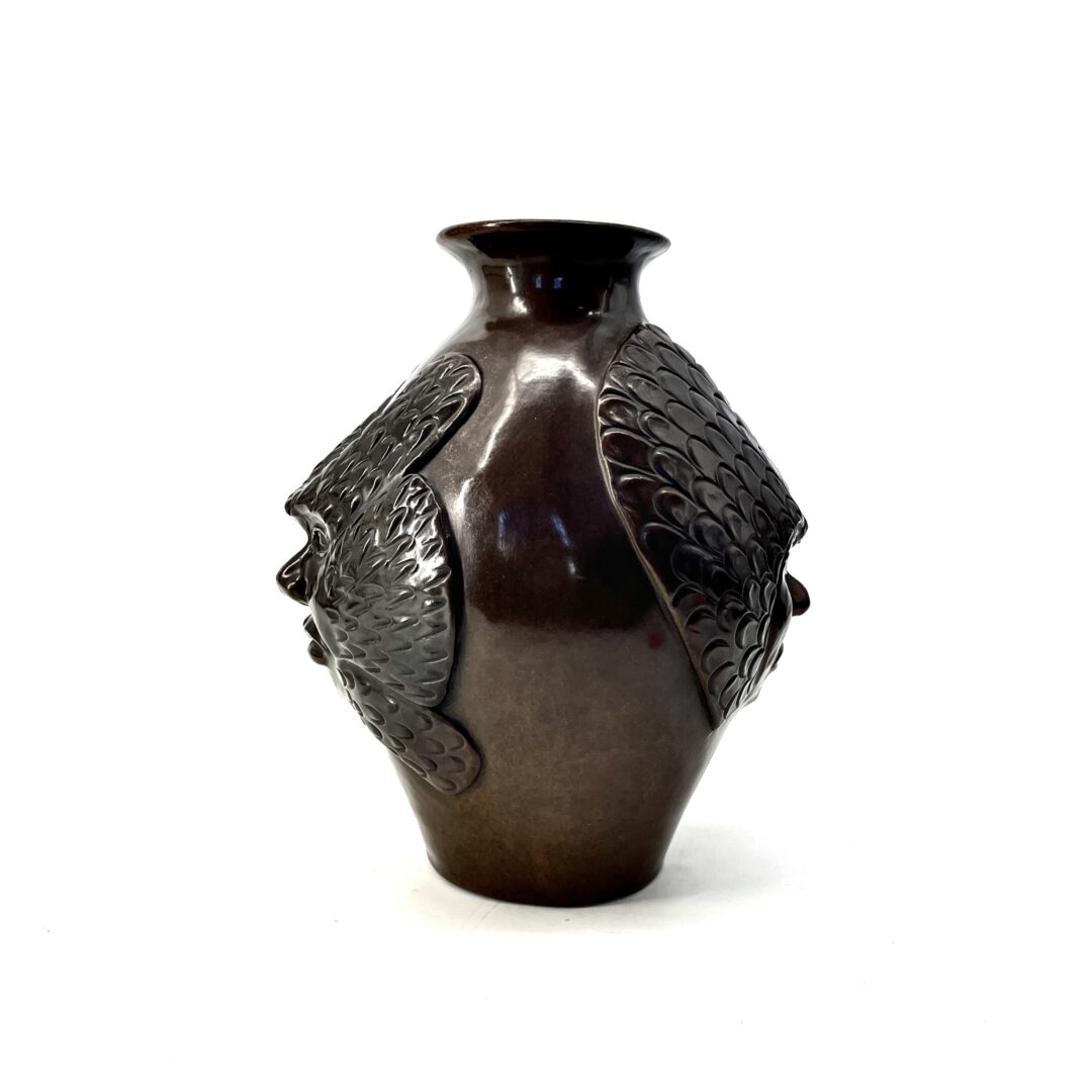 One original hand-carved vase by Inuit artist, Yvo Samgushak. One vase with a shaman's face sculpted in cast bronze.
