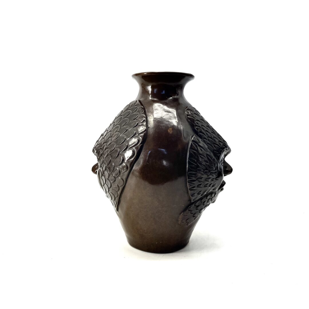 One original hand-carved vase by Inuit artist, Yvo Samgushak. One vase with a shaman's face sculpted in cast bronze.
