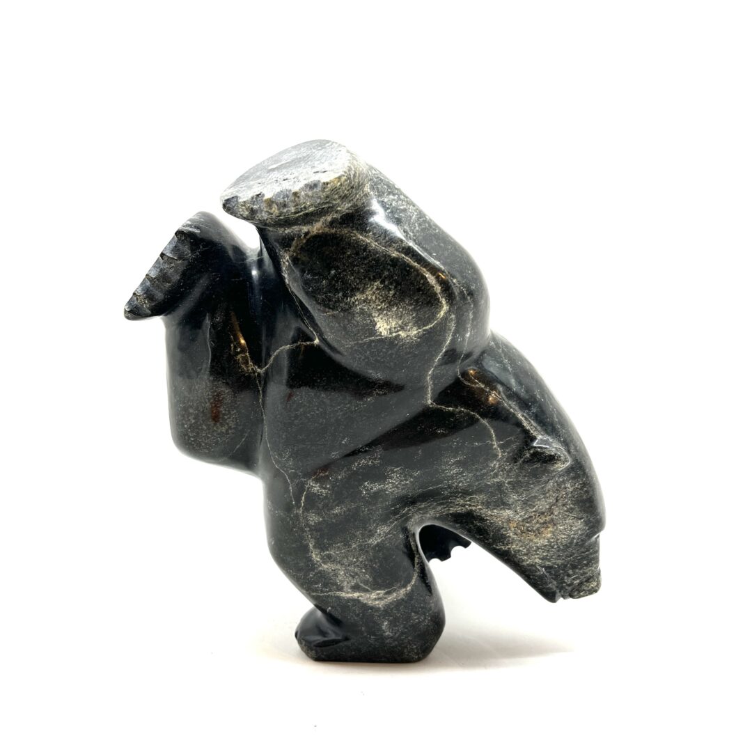 One original hand-carved sculpture by Inuit artist, Samonie Shaa. One three-way dancing bear carved out of serpentine.