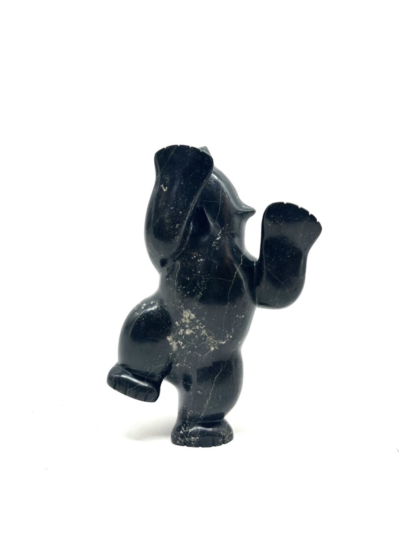 One original hand-carved sculpture by Inuit artist, Markoosie Papigatuk. One dancing bear carved out of serpentine.